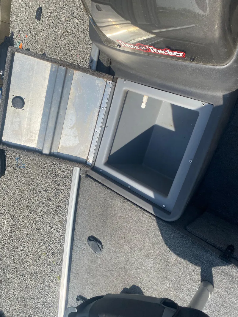 Slide: The Image of 2019 Bass Tracker Classic boat storage compartment with open lid, showing interior space. - 11