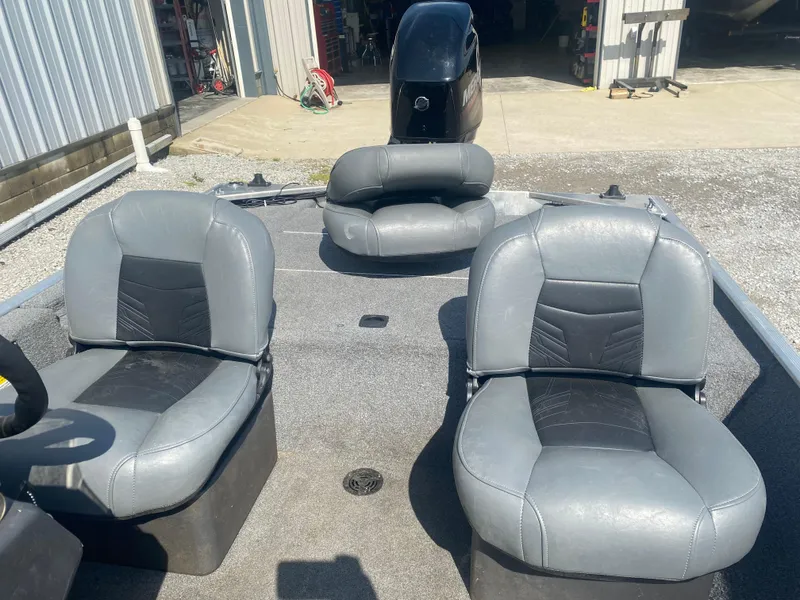 Slide: The Image of 2019 Bass Tracker Classic boat with gray seating and outboard motor in a sunny setting. - 16