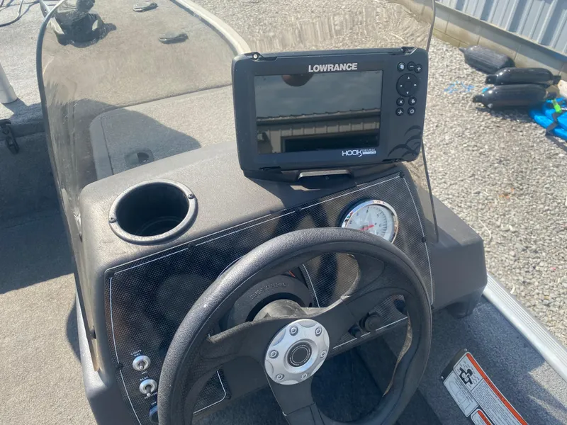 Slide: The Image of 2019 Bass Tracker Classic boat dashboard with Lowrance fish finder and steering wheel. - 9