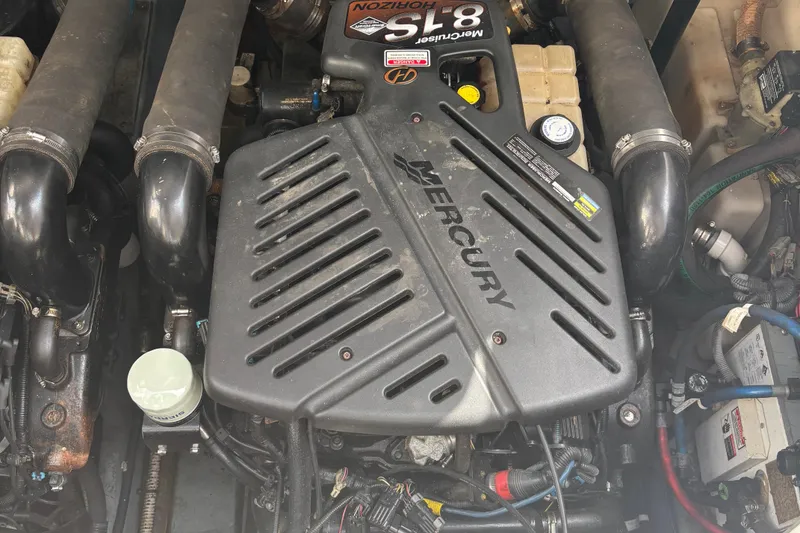 Slide: The Image of Engine of a 2003 Sea Ray 340 Sundancer boat, featuring a Mercury 5.8L engine. - 16