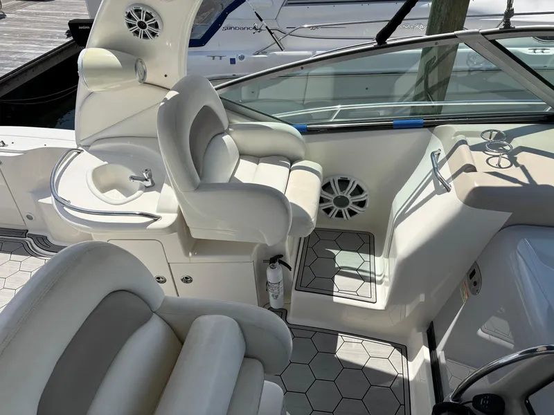 Slide: The Image of 2003 Sea Ray 340 Sundancer cockpit with white seating and modern controls. - 5