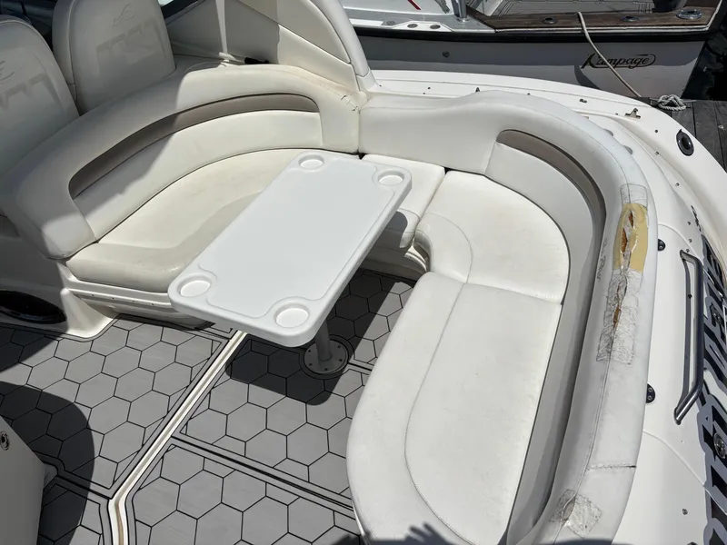 Slide: The Image of 2003 Sea Ray 340 Sundancer boat seating area with white cushions and hexagonal floor design. - 8