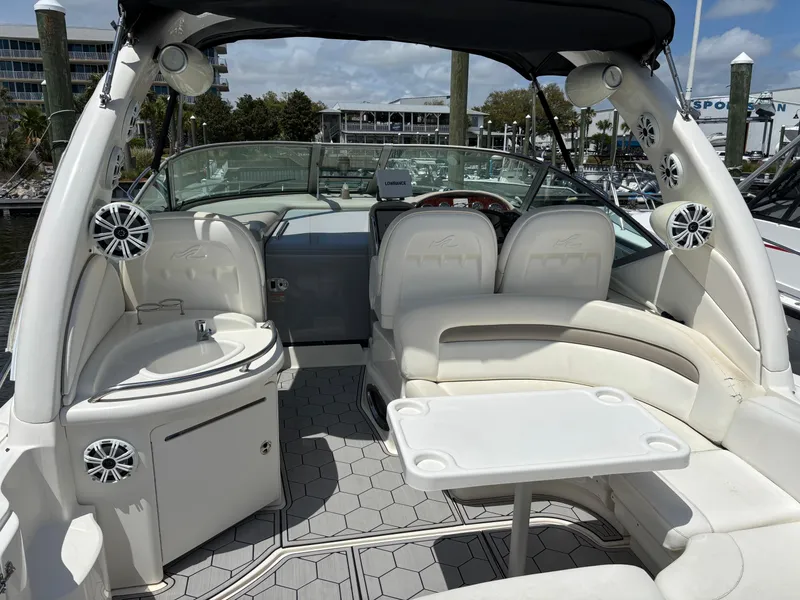 Slide: The Image of 2003 Sea Ray 340 Sundancer boat interior with seating and table, docked at marina. - 9