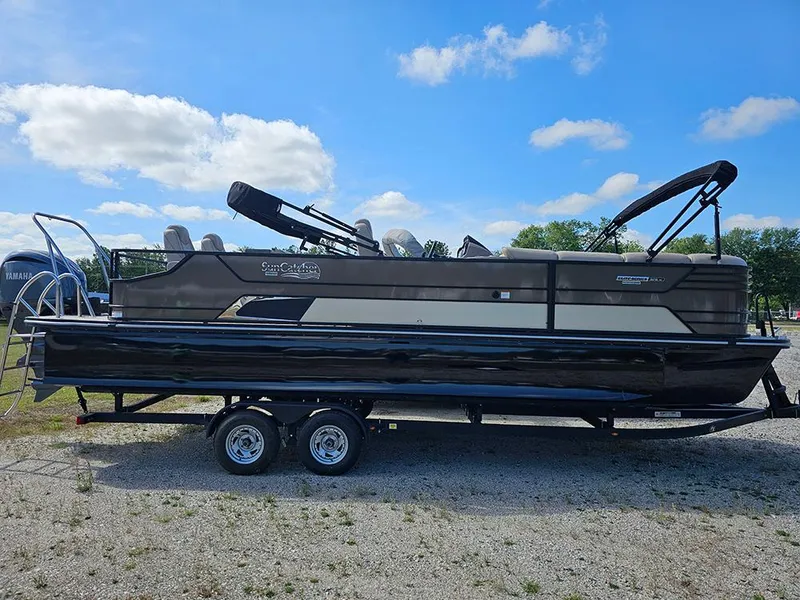 Slide: The Image of 2024 SunCatcher Elite 326 SE pontoon boat on trailer under blue sky. - 1