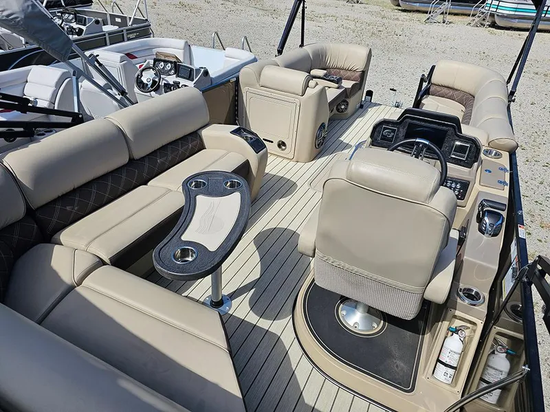 Slide: The Image of 2024 SunCatcher Elite 326 SE pontoon boat interior with luxurious seating and modern dashboard. - 13
