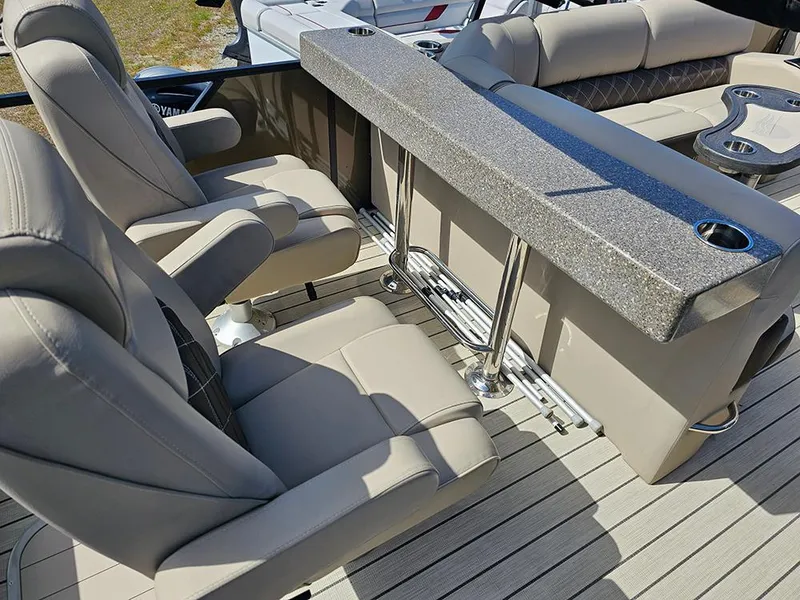 Slide: The Image of 2024 SunCatcher Elite 326 SE boat interior with plush seating and sleek bar area. - 14