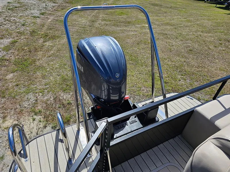 Slide: The Image of 2024 SunCatcher Elite 326 SE boat with Yamaha outboard motor on grassy area. - 17