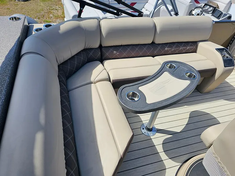 Slide: The Image of 2024 SunCatcher Elite 326 SE boat interior with plush seating and a stylish table. - 18