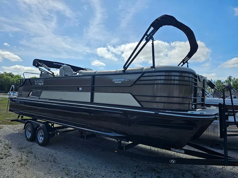 Slide: The Image of 2024 SunCatcher Elite 326 SE pontoon boat on trailer under blue sky. - 2