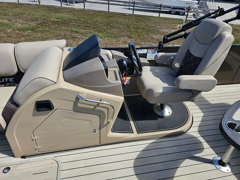 Slide: The Image of 2024 SunCatcher Elite 326 SE boat interior with captain's chair and control console. - 21