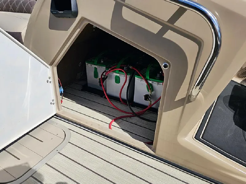 Slide: The Image of 2024 SunCatcher Elite 326 SE boat battery compartment with visible wiring. - 22