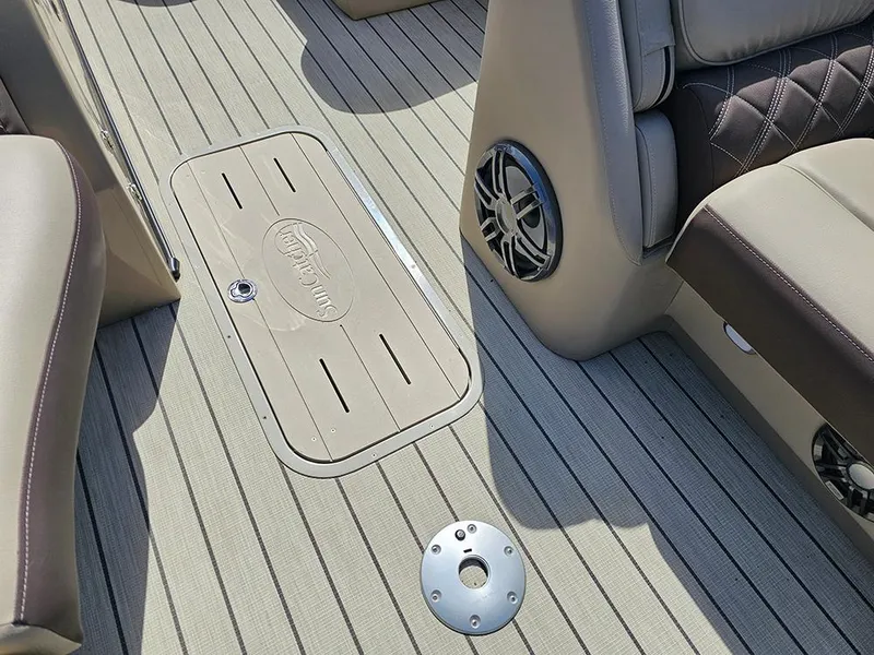 Slide: The Image of 2024 SunCatcher Elite 326 SE boat interior with beige flooring and speaker system. - 29