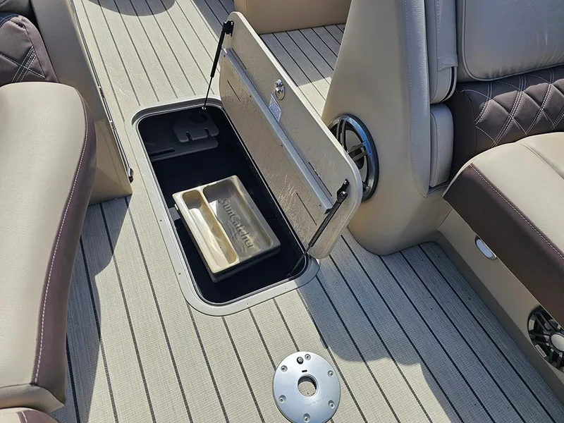 Slide: The Image of 2024 SunCatcher Elite 326 SE boat interior with open storage compartment on deck. - 30