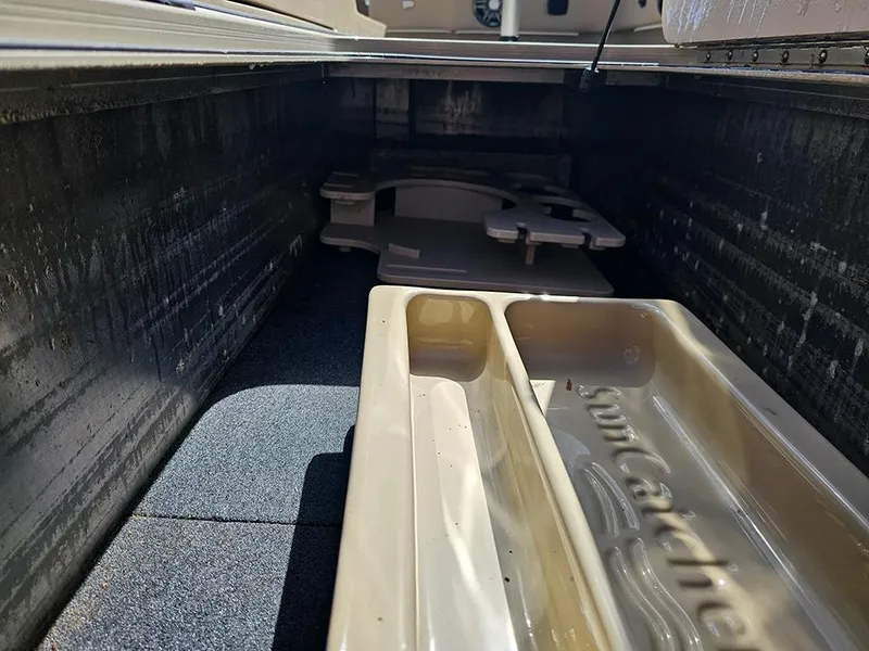 Slide: The Image of 2024 SunCatcher Elite 326 SE storage compartment with beige interior and SunCatcher branding. - 31