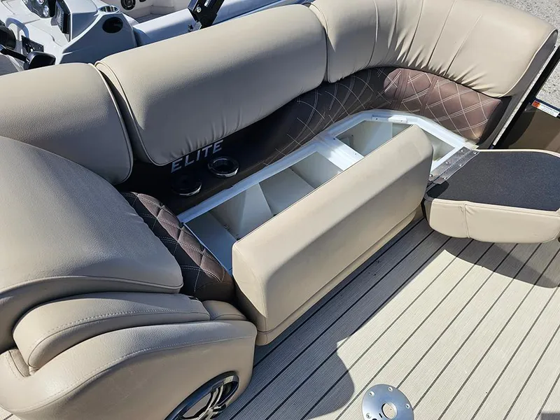 Slide: The Image of 2024 SunCatcher Elite 326 SE boat interior with beige seating and storage compartment. - 33