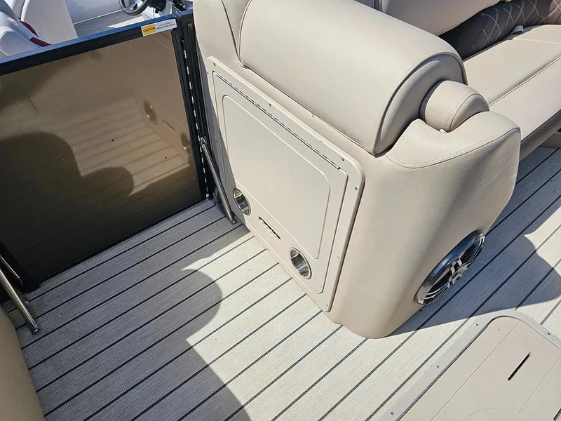 Slide: The Image of 2024 SunCatcher Elite 326 SE boat interior with beige seating and striped flooring. - 34