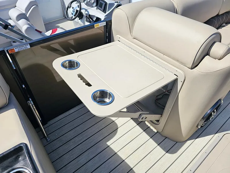 Slide: The Image of 2024 SunCatcher Elite 326 SE boat interior with foldable table and cup holders. - 35