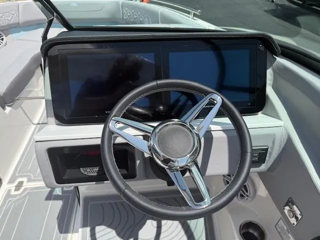 Slide: The Image of 2025 Regal LS6 Surf boat dashboard with dual screens and sleek steering wheel. - 11