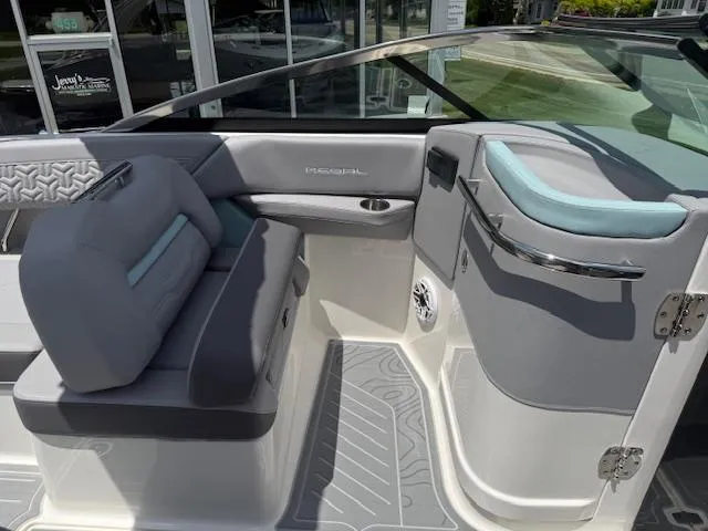 Slide: The Image of 2025 Regal LS6 Surf boat interior with gray seating and modern design. - 12