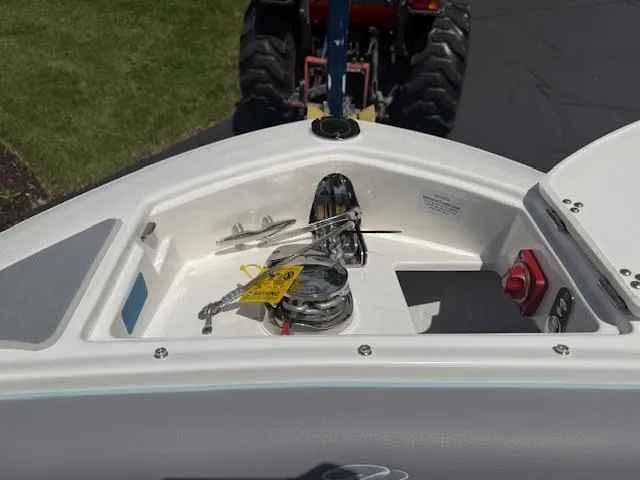 Slide: The Image of 2025 Regal LS6 Surf boat anchor compartment with winch and controls. - 21