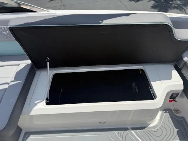 Slide: The Image of Open storage compartment on 2025 Regal LS6 Surf boat. - 28
