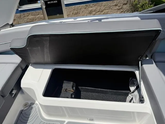 Slide: The Image of Open storage compartment in 2025 Regal LS6 Surf boat, showcasing spacious interior. - 29