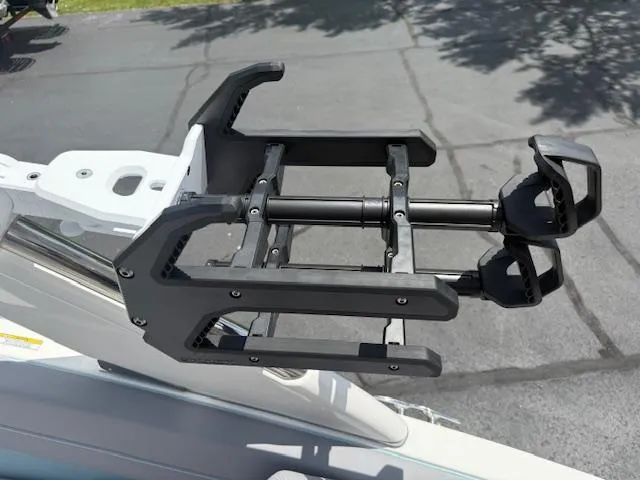 Slide: The Image of Wakeboard rack on a 2025 Regal LS6 Surf boat, mounted on a sunny day. - 9