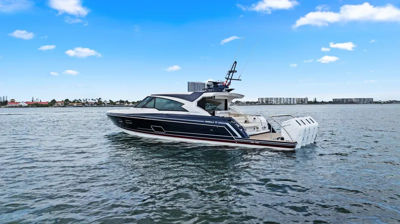 Slide: The Image of 2025 Formula 500 Super Sport Crossover yacht cruising on a calm sea under a clear sky. - 10
