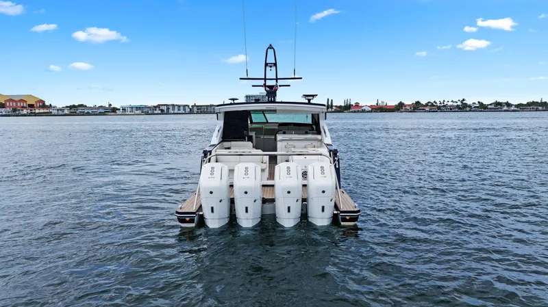 Slide: The Image of 2025 Formula 500 Super Sport Crossover boat on water, rear view with multiple engines. - 13