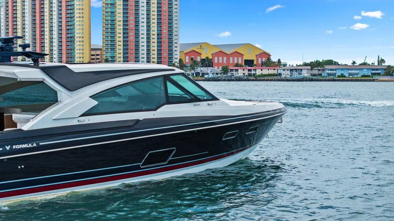 Slide: The Image of 2025 Formula 500 Super Sport Crossover yacht cruising near colorful waterfront buildings. - 17
