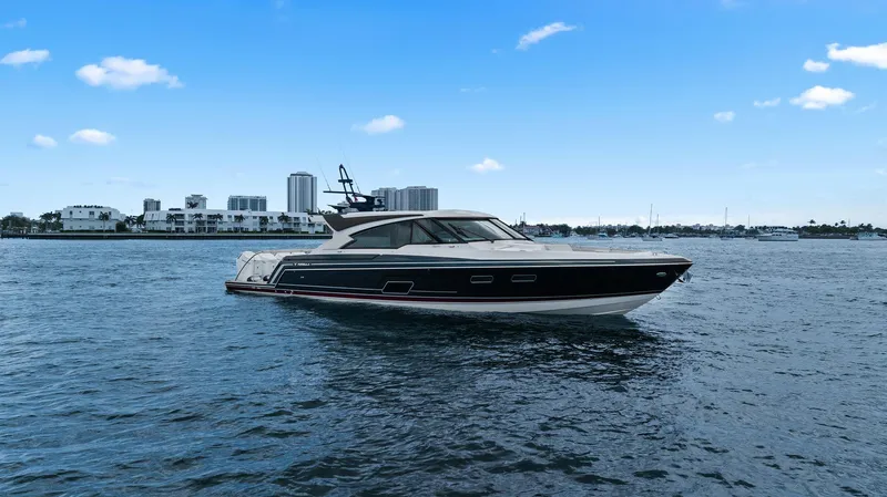 Slide: The Image of 2025 Formula 500 Super Sport Crossover yacht on calm water with city skyline background. - 2