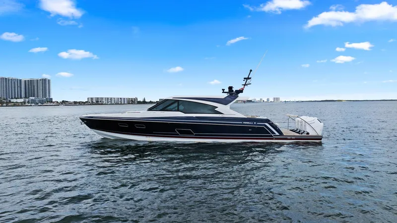 Slide: The Image of 2025 Formula 500 Super Sport Crossover yacht on calm water under a clear blue sky. - 7