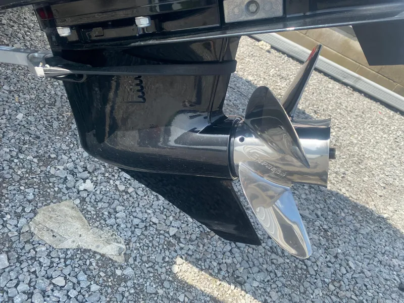 Slide: The Image of 2021 Tracker Pro Guide V-16 WT boat propeller on gravel surface. - 10