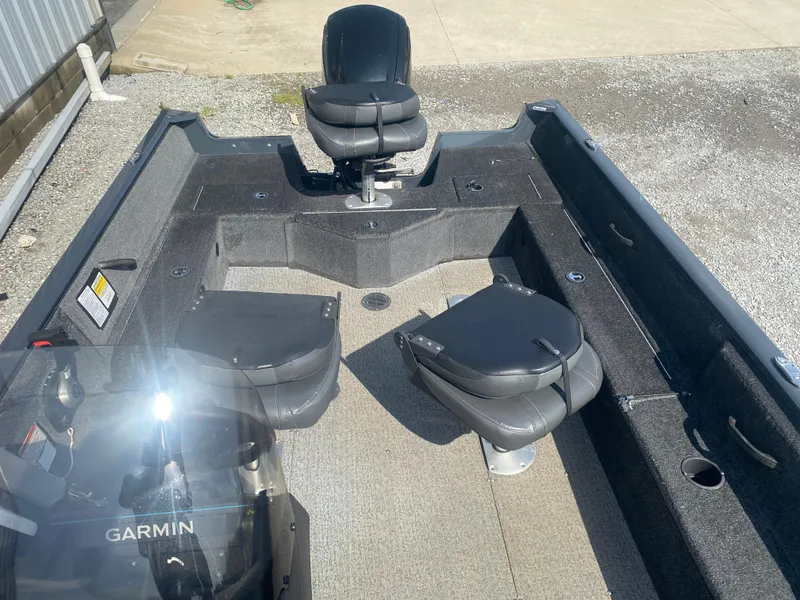 Slide: The Image of 2021 Tracker Pro Guide V-16 WT boat interior with seating and Garmin equipment. - 15