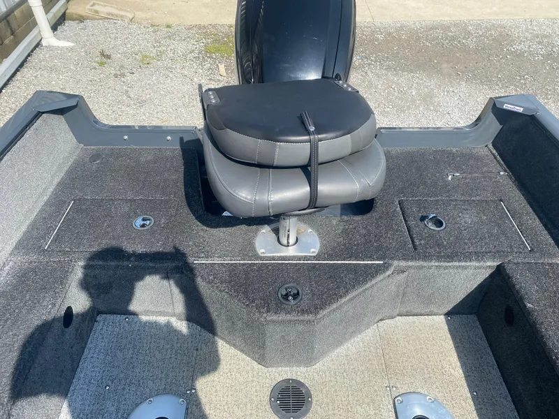 Slide: The Image of 2021 Tracker Pro Guide V-16 WT boat interior with cushioned seat and storage compartments. - 17
