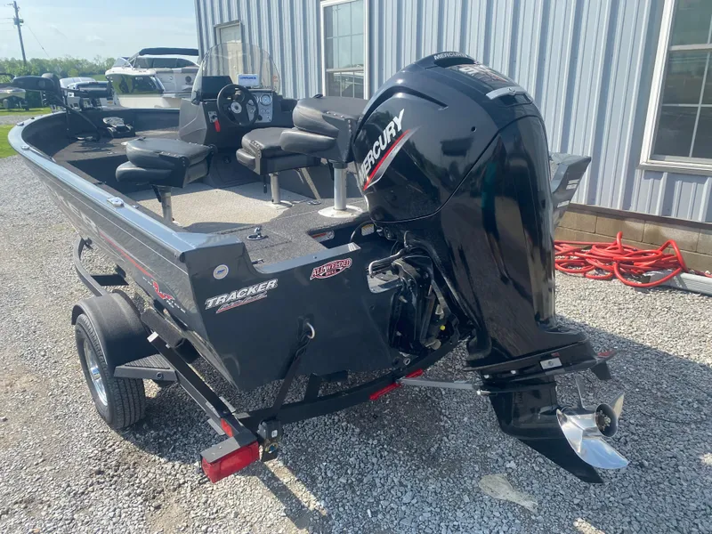 Slide: The Image of 2021 Tracker Pro Guide V-16 WT boat with Mercury outboard motor, parked on gravel. - 7