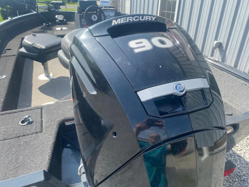 Slide: The Image of 2021 Tracker Pro Guide V-16 WT with Mercury 90 outboard engine, parked near a building. - 8