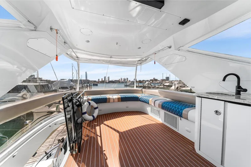 Slide: The Image of Luxurious 2007 Marquis 55 LS yacht deck with seating and city skyline view. - 11