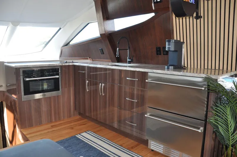 Slide: The Image of Luxurious kitchen interior of 2007 Marquis 55 LS yacht with modern appliances and wood finish. - 25