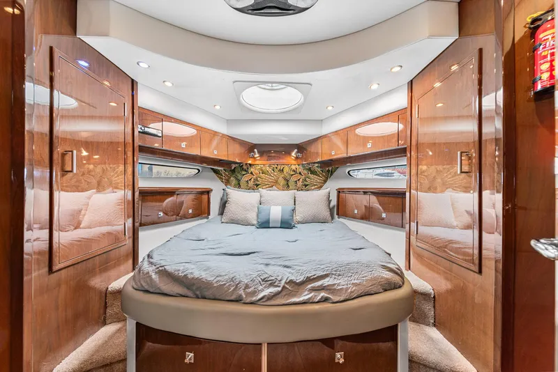 Slide: The Image of Luxurious 2007 Marquis 55 LS yacht bedroom with elegant wood paneling and plush bedding. - 29
