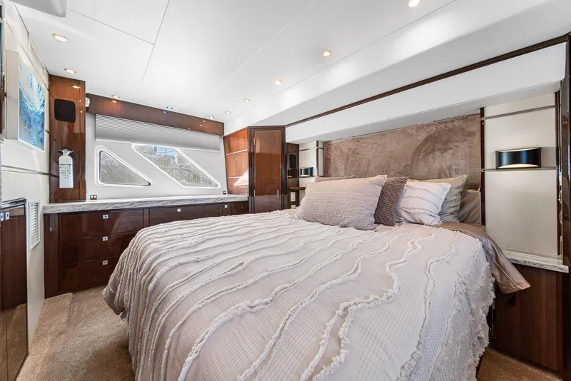 Slide: The Image of Luxurious bedroom interior of a 2007 Marquis 55 LS yacht with elegant bedding and wood accents. - 30