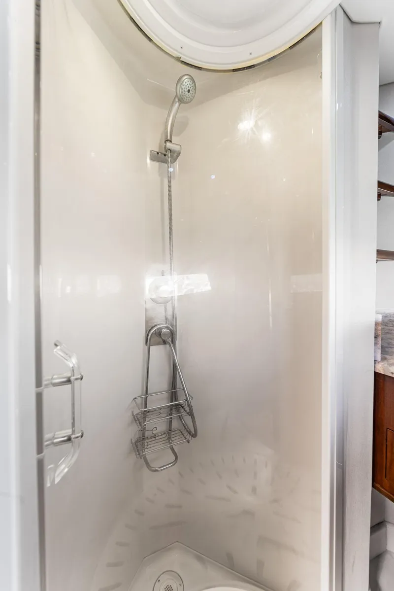 Slide: The Image of Shower area in 2007 Marquis 55 LS yacht with chrome fixtures and storage basket. - 42