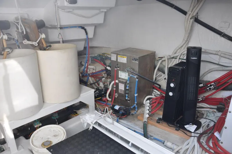 Slide: The Image of Engine room of a 2007 Marquis 55 LS yacht with various equipment and wiring. - 47