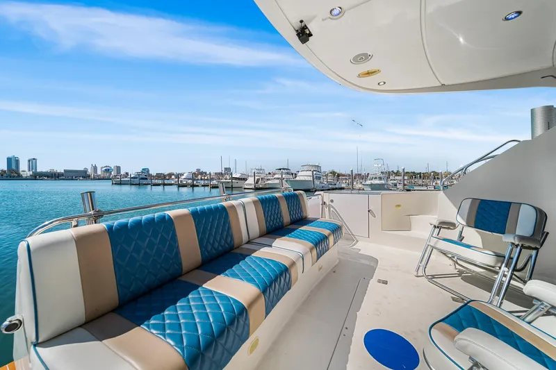 Slide: The Image of Luxurious 2007 Marquis 55 LS yacht with spacious seating, docked in a scenic marina. - 8