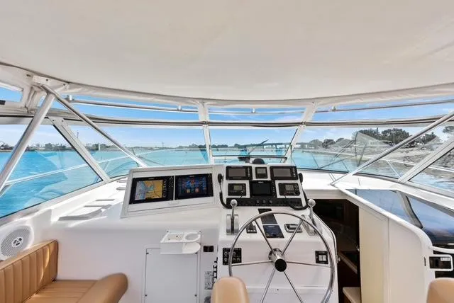 Slide: The Image of 1998 Viking 43 Open yacht helm with navigation equipment and panoramic ocean view. - 10