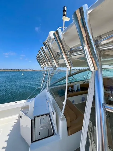 Slide: The Image of 1998 Viking 43 Open yacht with rod holders, docked on a sunny day. - 18