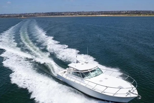 Slide: The Image of 1998 Viking 43 Open yacht cruising on open water, leaving a wake behind. - 2