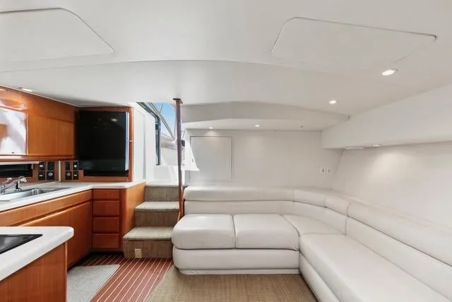 Slide: The Image of Luxurious interior of a 1998 Viking 43 Open yacht with white seating and wooden cabinetry. - 28