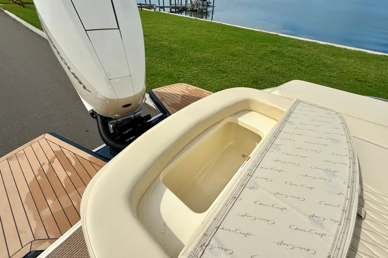 Slide: The Image of 2026 Chris-Craft Sportster 28 boat with Mercury engine, featuring elegant deck and storage area. - 12