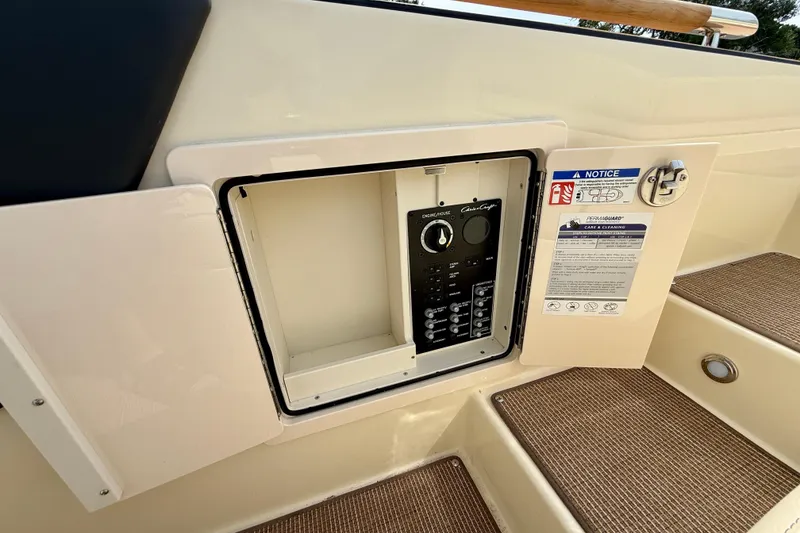 Slide: The Image of 2026 Chris-Craft Sportster 28 control panel with open access door and safety notice. - 17